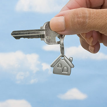 Image of homeowners holding a house key.
